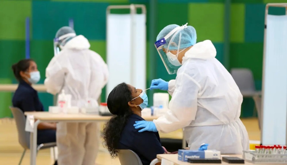 Medical staff members carry out COVID-19 nose swab tests on teachers and school employees in Dubai.