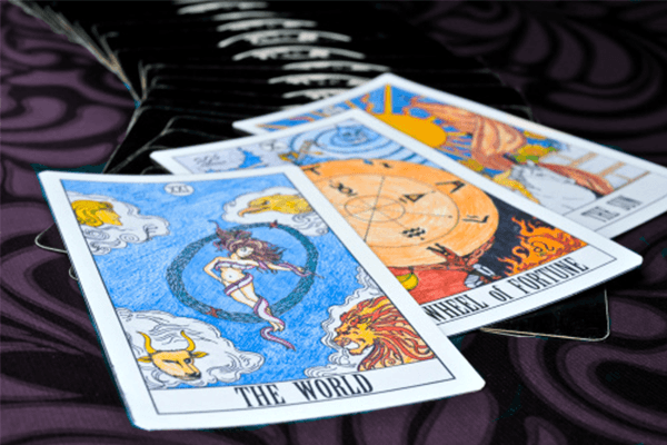 Tarot cards, the world, wheel of fortune, and the sun.