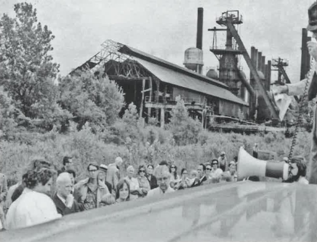 A Picture of Randall Oaks using a bullhorn urging anyone interested in exploring alternatives to the Sloss demolition to gather at his Morris Ave restaurant on Oak Street