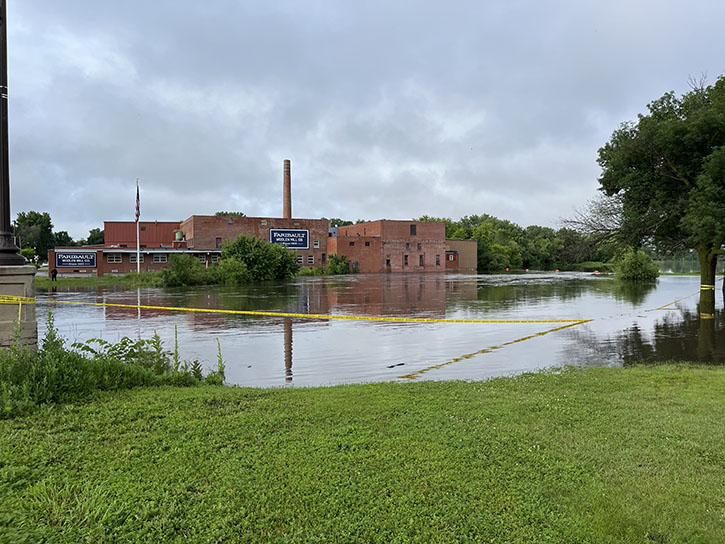 Flooded land in Faribault, Minn., with caution tape.