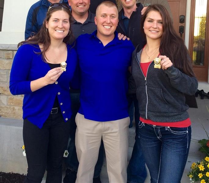Brett poses with some of Garrett Schloesser's Daughters holding their dad's badge number
