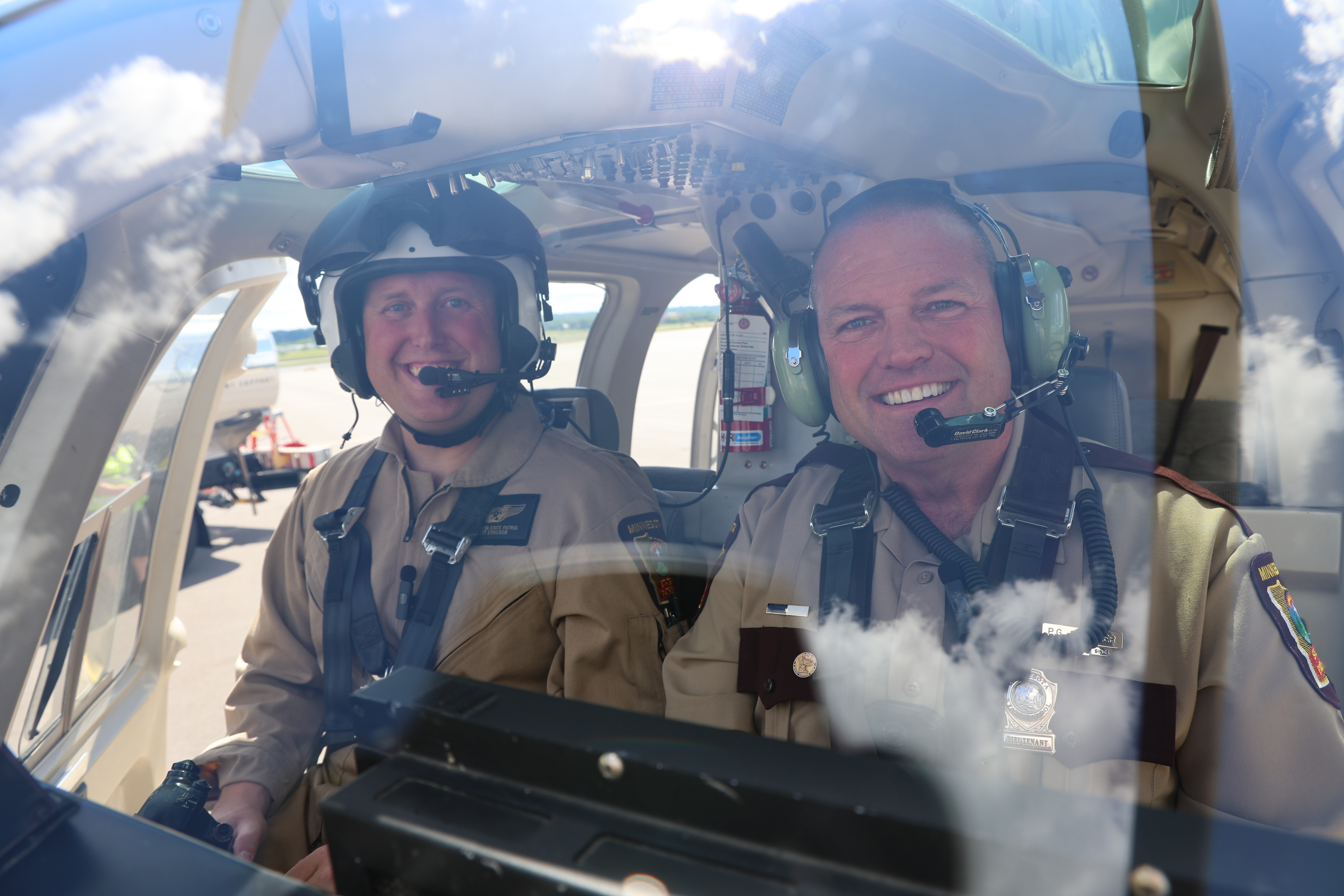 Brett and Paul Stricker in the cockpit of a State Patrol helicopter