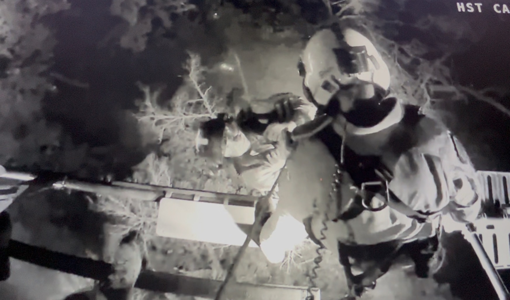 The Minnesota Air Rescue Team practices pulling a person from a wooded area after dark as part of its night rescue training