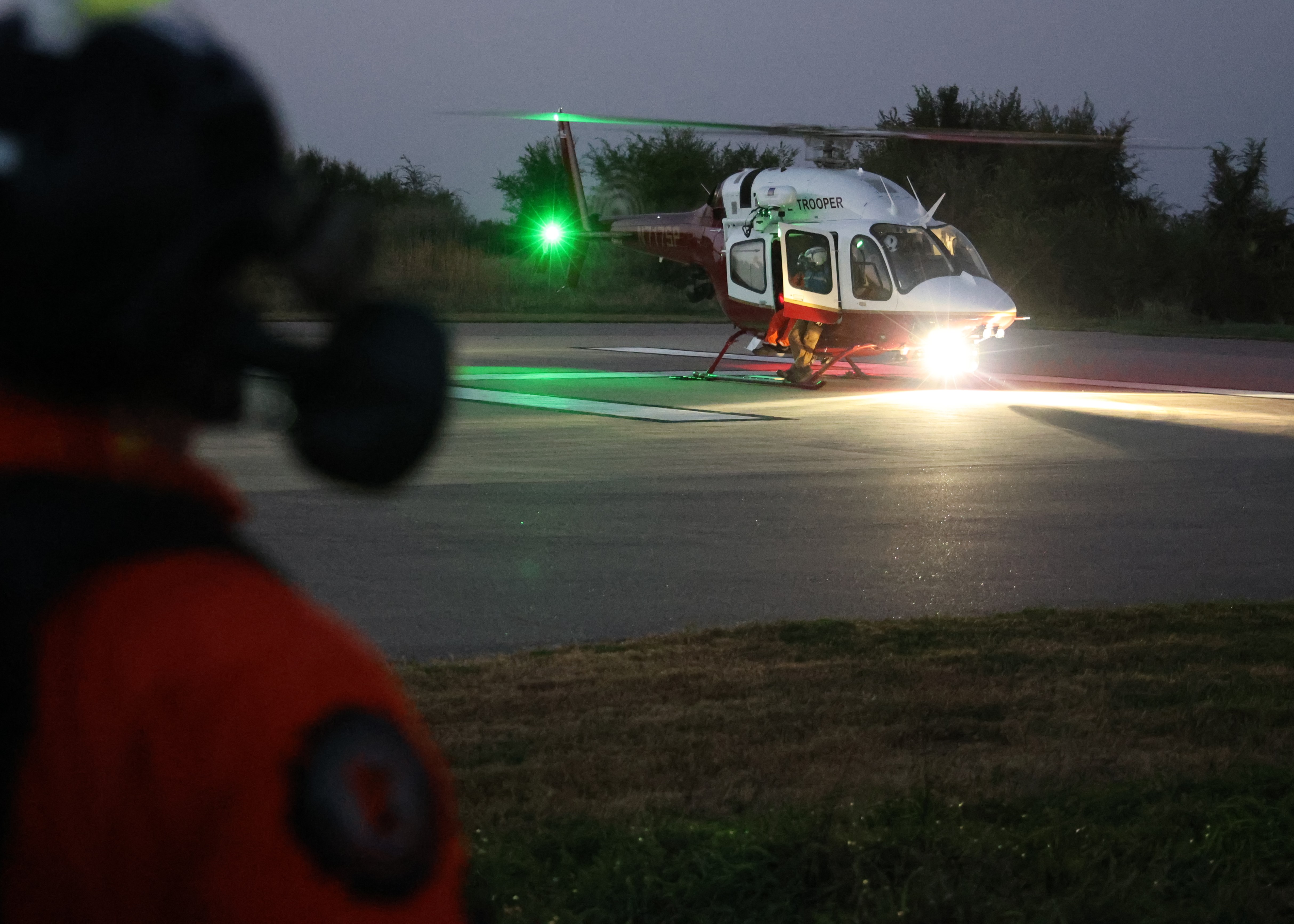 A member of the Minnesota Air Rescue Team looks on as Trooper 7 prepares for takeoff