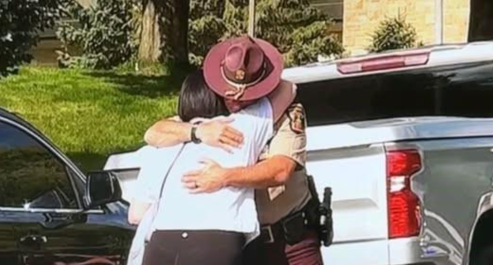 Trooper hugging woman outside Annunciation Church and School