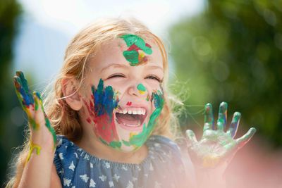 laughing girl with paint on her face