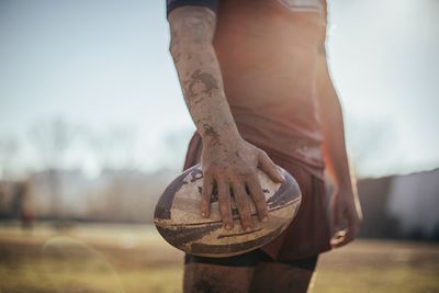 a rugby ball in hand