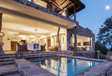 The pool area at night at Beho Beho Camp, luxury hotel in Tanzania