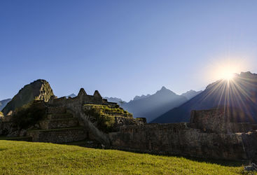 sun rising over machu picchu