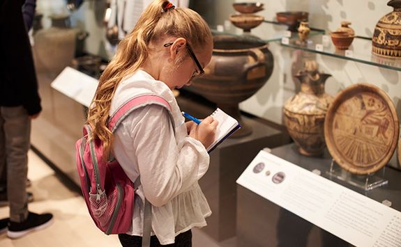 child making notes in the British Museum