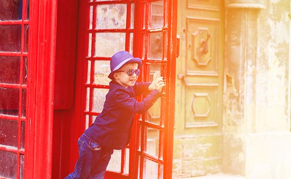 Boy running out of a London telephone box