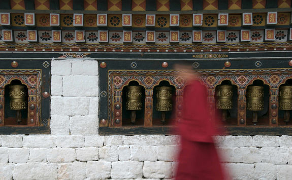 monk and praying wheels