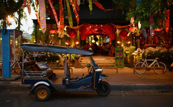 tuk tuk parked in front of a restaurant