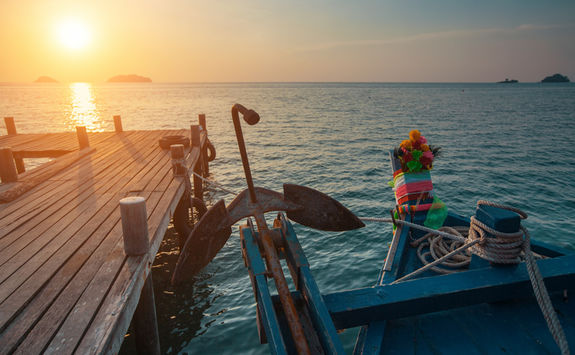 wooden fishing boat at sunset