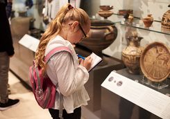 child making notes in the British Museum