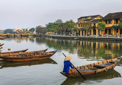 Vietnamese woman padding in old town in Hoi An