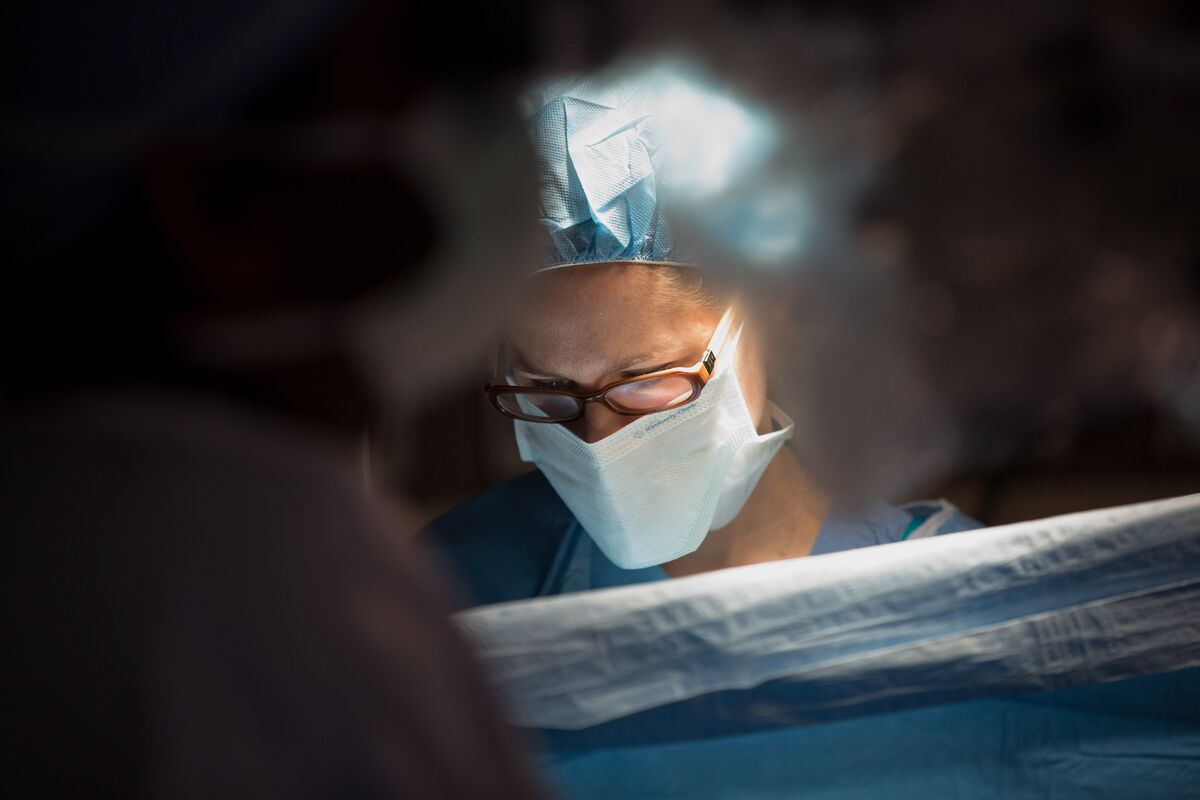 A doctor performing surgery at a spinal clinic