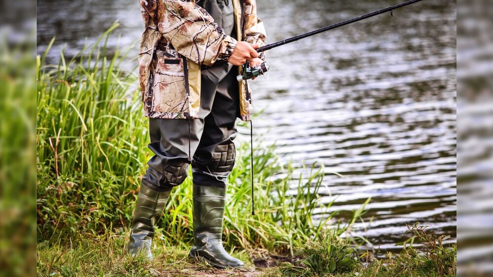 Man standing fishing 16 9