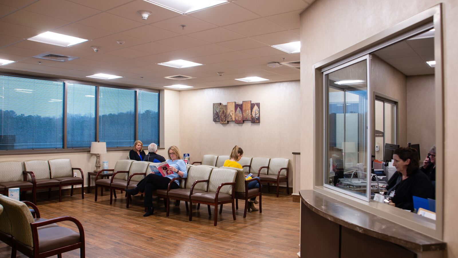 Occupied waiting room, with check in desk