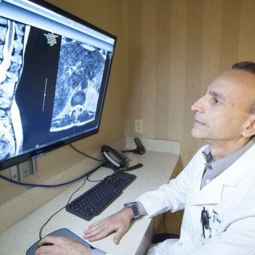 Dr. Carro at Semmes Murphey Looing at a Computer