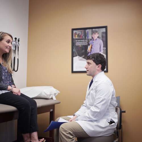 Dr. Chris Nickele sitting with a patient at Semmes Murphey