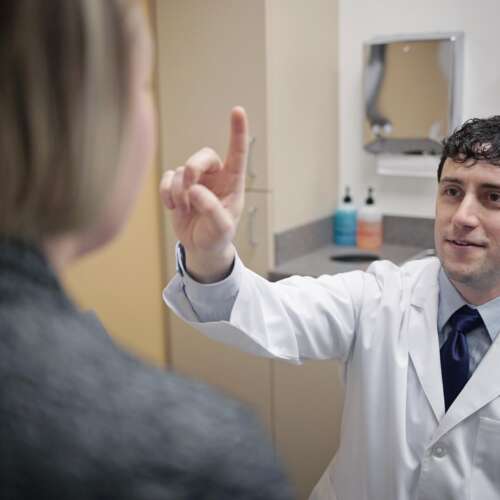Dr. Chris Nickele Checking Cognitive Function with a Patient at Semmes Murphey Clinic