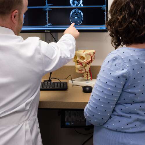 Dr. Hoit pointing to imaging on a computer at Semmes Murphey