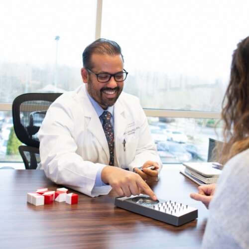 Dr. Baughman Smiling and Performing a Test in Neuropsychology Semmes Murphey