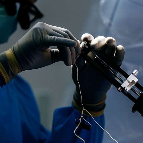 Doctors hands using surgical instruments