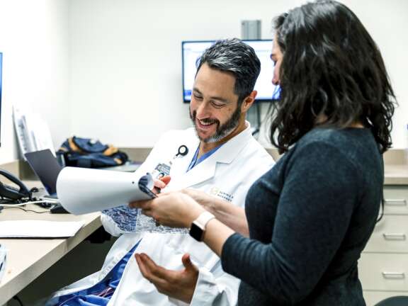Doctor Elijovich looks over paper with nurse 0021