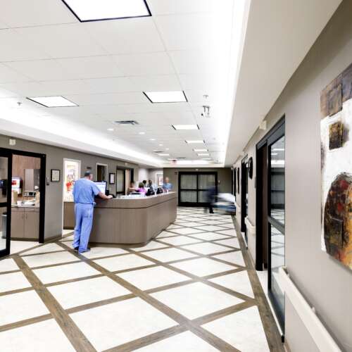 Wide Shot of the Recovery Area in a Same Day Surgery Center With a Doctor Standing in the Distance