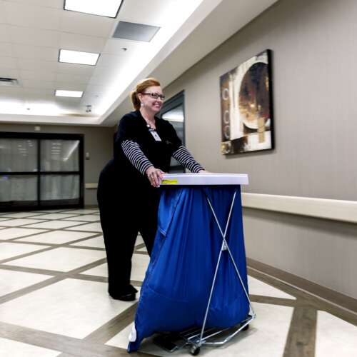 Nurse with laundry at Semmes Murphey