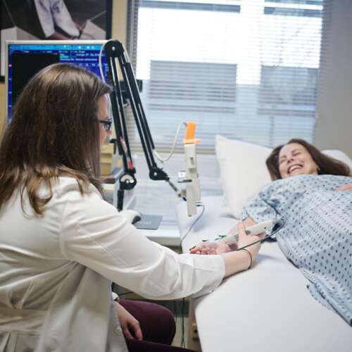 Nurse giving an EEG/NCS test to a smiling patient