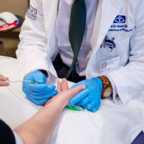 Doctor and Patient Hands, Testing at Semmes Murphey Clinic, Brain and Spine Care