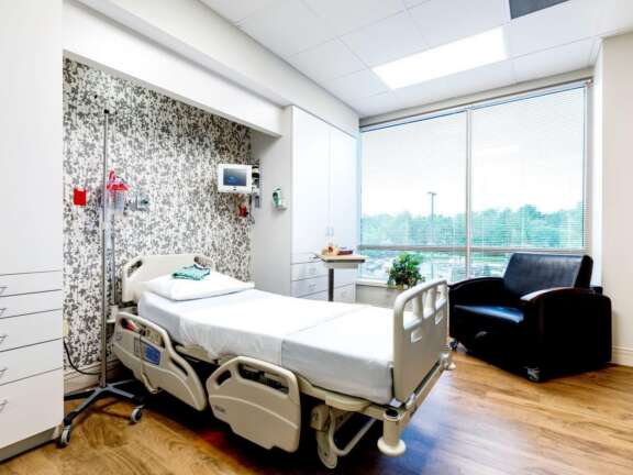 Recovery Room With a Bed, Chair, and Window
