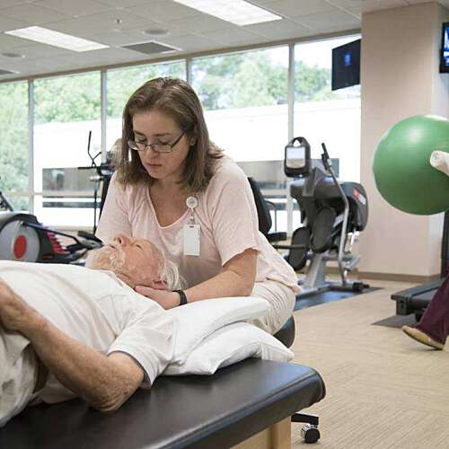 Dr. Graham Examining a Patient's Neck at Semmes Murphey