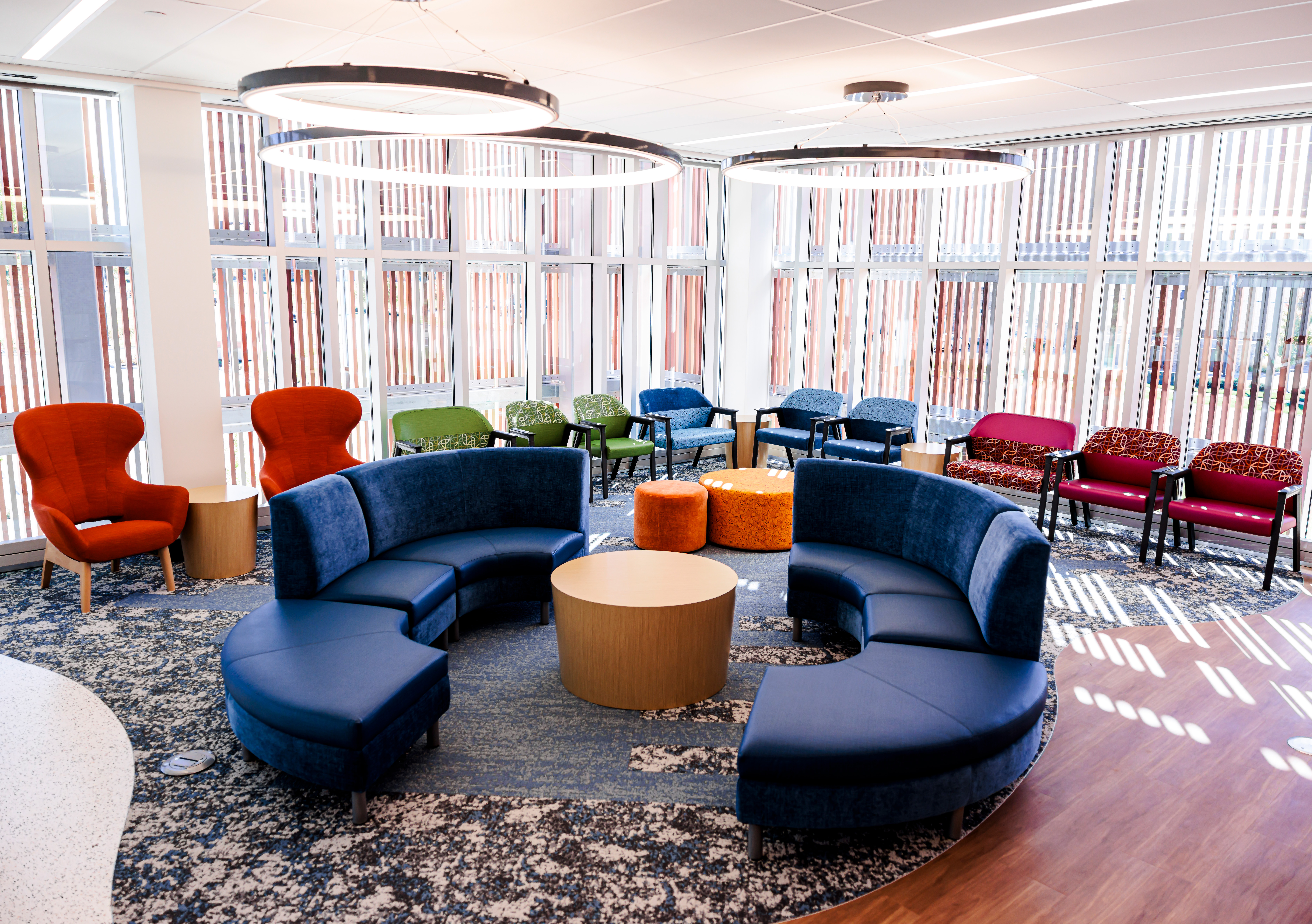 The location includes 60 brightly colored exam rooms and vibrant waiting spaces for patients.