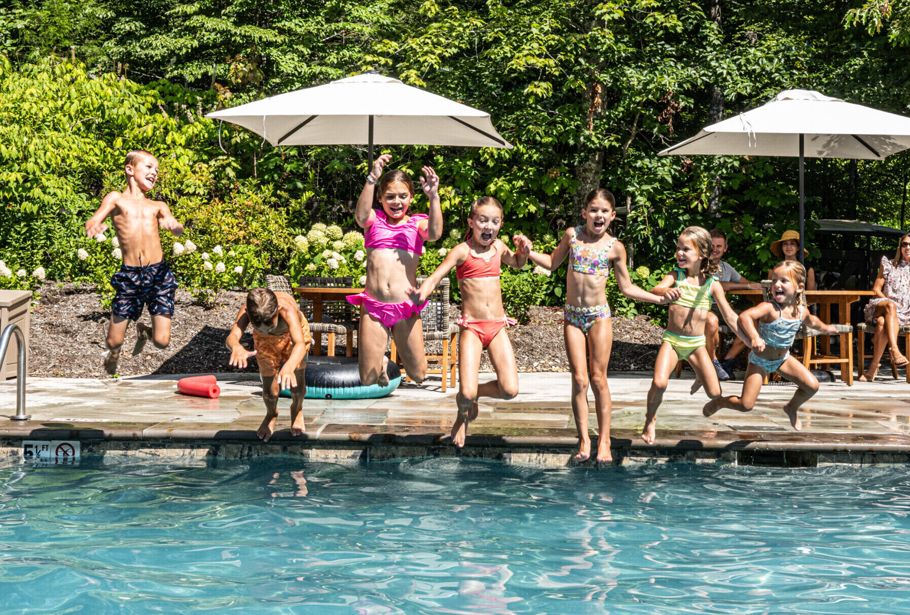 Group of Kids Jumping in Pool