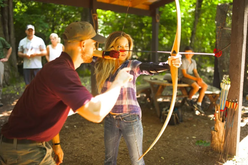 Girl Being Instructed on Archery