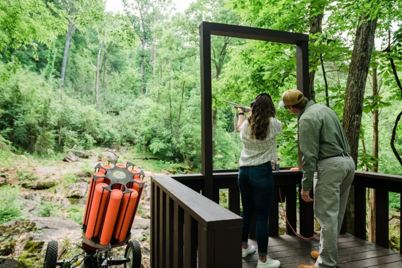 Girl Being Instructed on Clay Shooting