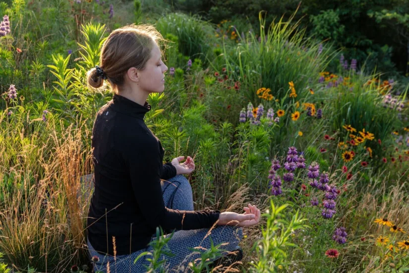 Woman Meditating Amongst Wildflowers