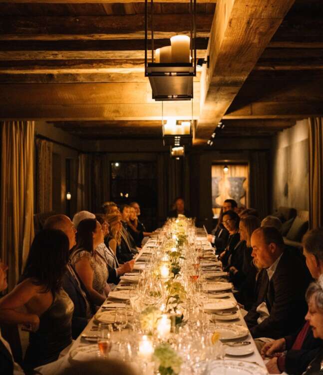 Group Having Dinner in the Wine Cellar