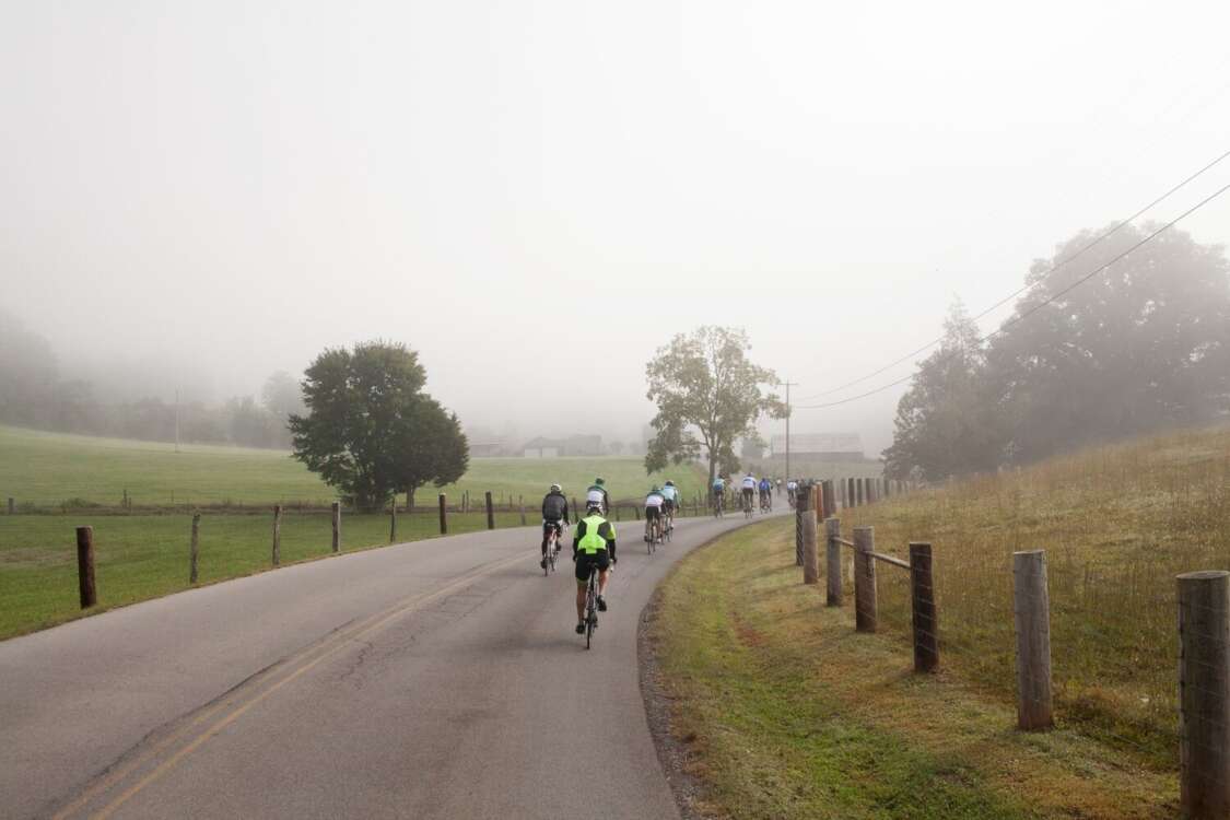 Cyclists Ride in Fog