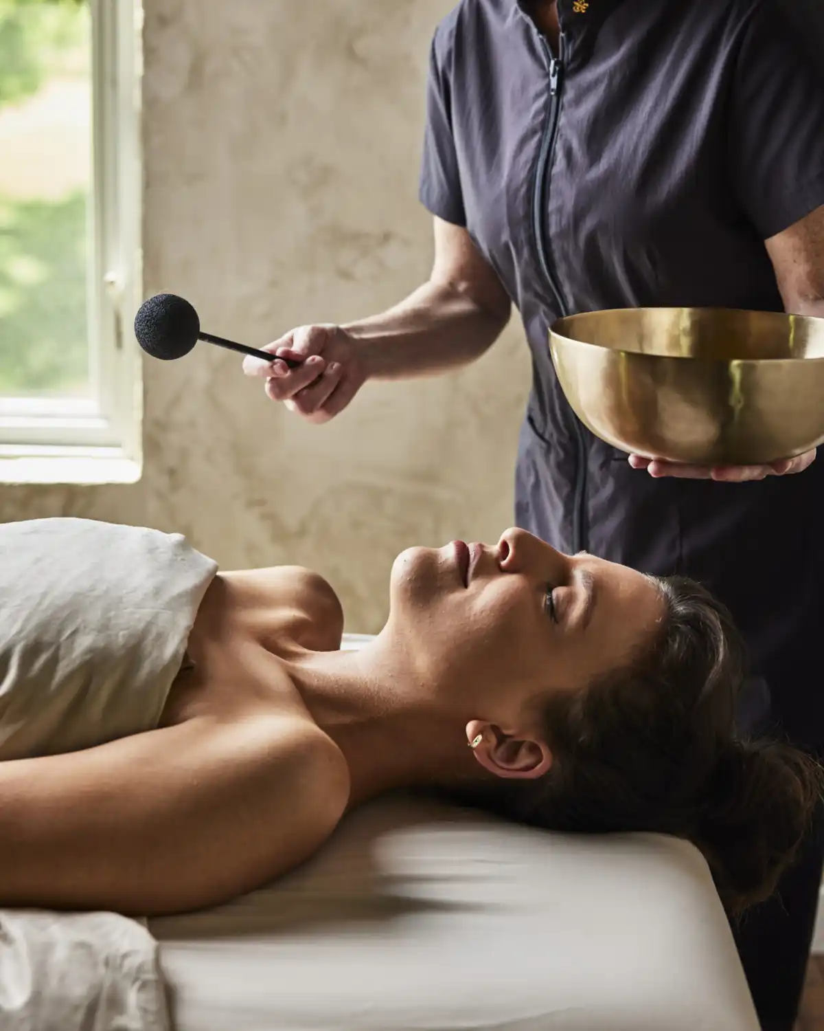 Woman Receiving a Sound Bathing Treatment