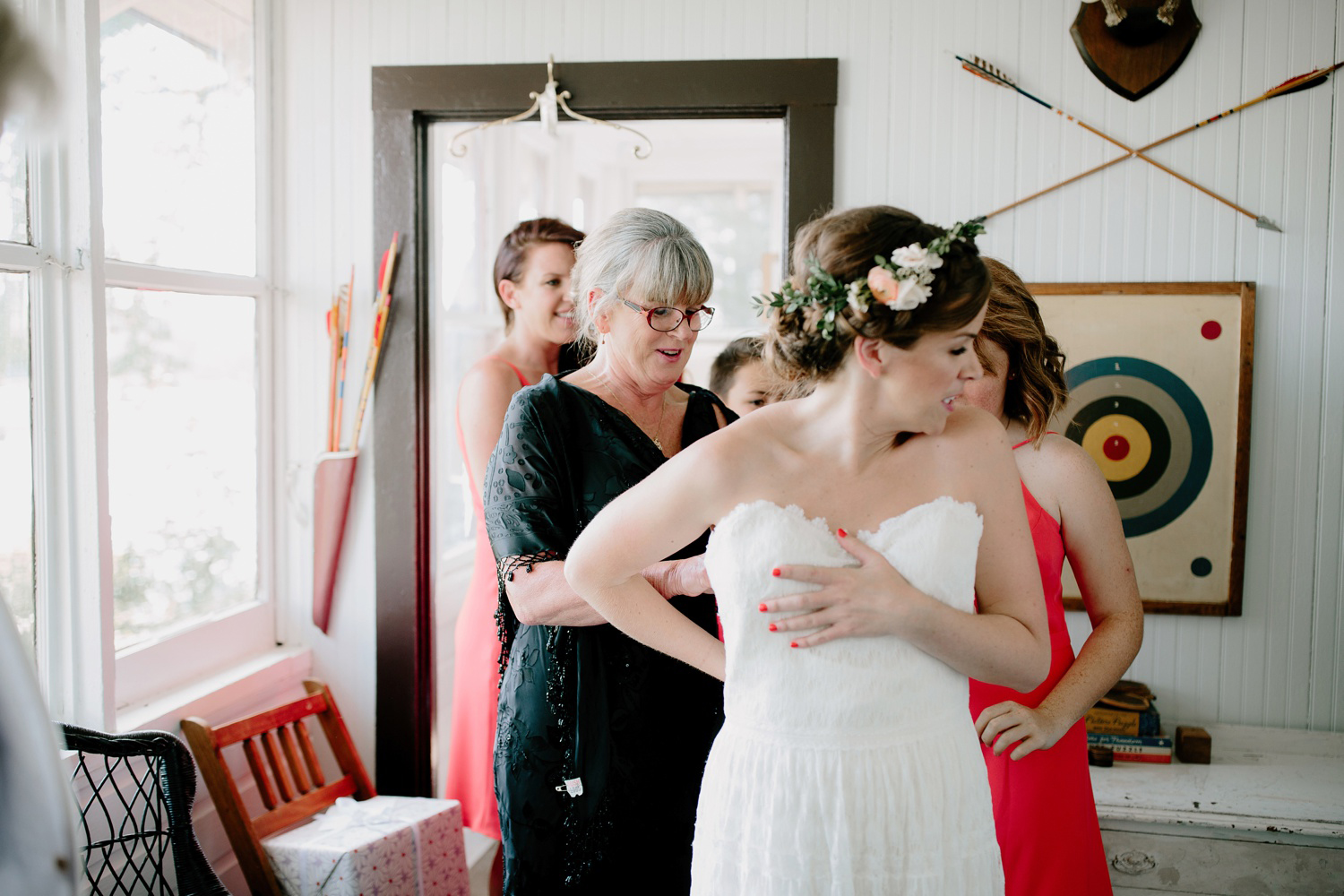 bride putting on dress at camp wandawega