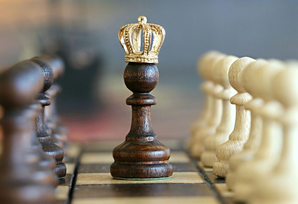 A crowned chess pawn standing tall on the board, symbolizing the top-ranked calendar budgeting app of 2025 and representing smart financial strategy and winning money management.