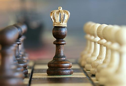 A crowned chess pawn standing tall on the board, symbolizing the top-ranked calendar budgeting app of 2025 and representing smart financial strategy and winning money management.