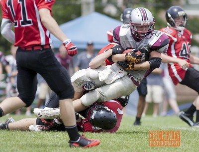 Limestone District Grenadiers' Caleb Goodfellow is tackled during the second quarter. Goodfellow had twelve carries for 70-yards during the matchup. The Gmen fell victim to the Warriors in Ontario Varsity Football League action against the Mississauga Warriors on Sat., Jun 29 at Loyalist Collegiate and Vocational Institute.