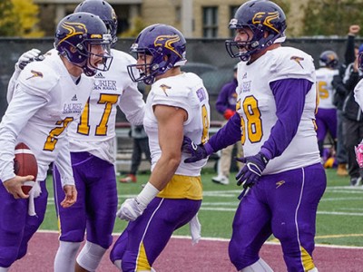 Laurier QB Eric Morelli, left, celebrates his second quarter touchdown on Saturday (Photo Credit: Bruce Bell)