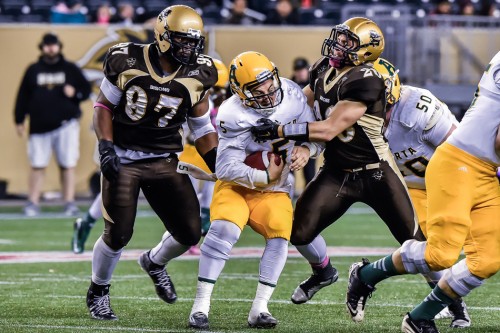 Mitchell Harrison (20) sacks Alberta Golden Bears quarter back (5) Ben Kopczynski Jeff Miller-Bison Sports-